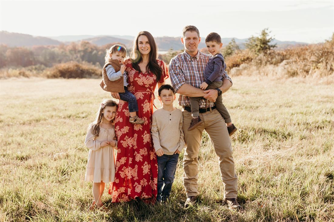 Tyler and Kelly with their four children in the pasture at Mountain Valley Farms