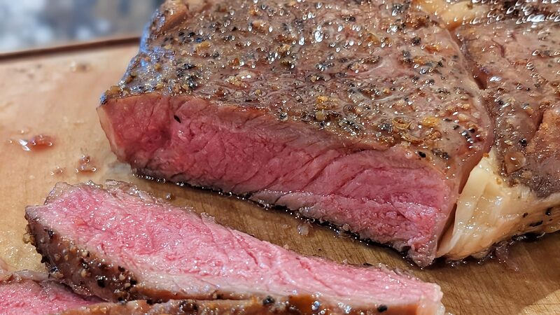 Sliced grass-fed ribeye from Mountain Valley Farms showing a rosy medium-center